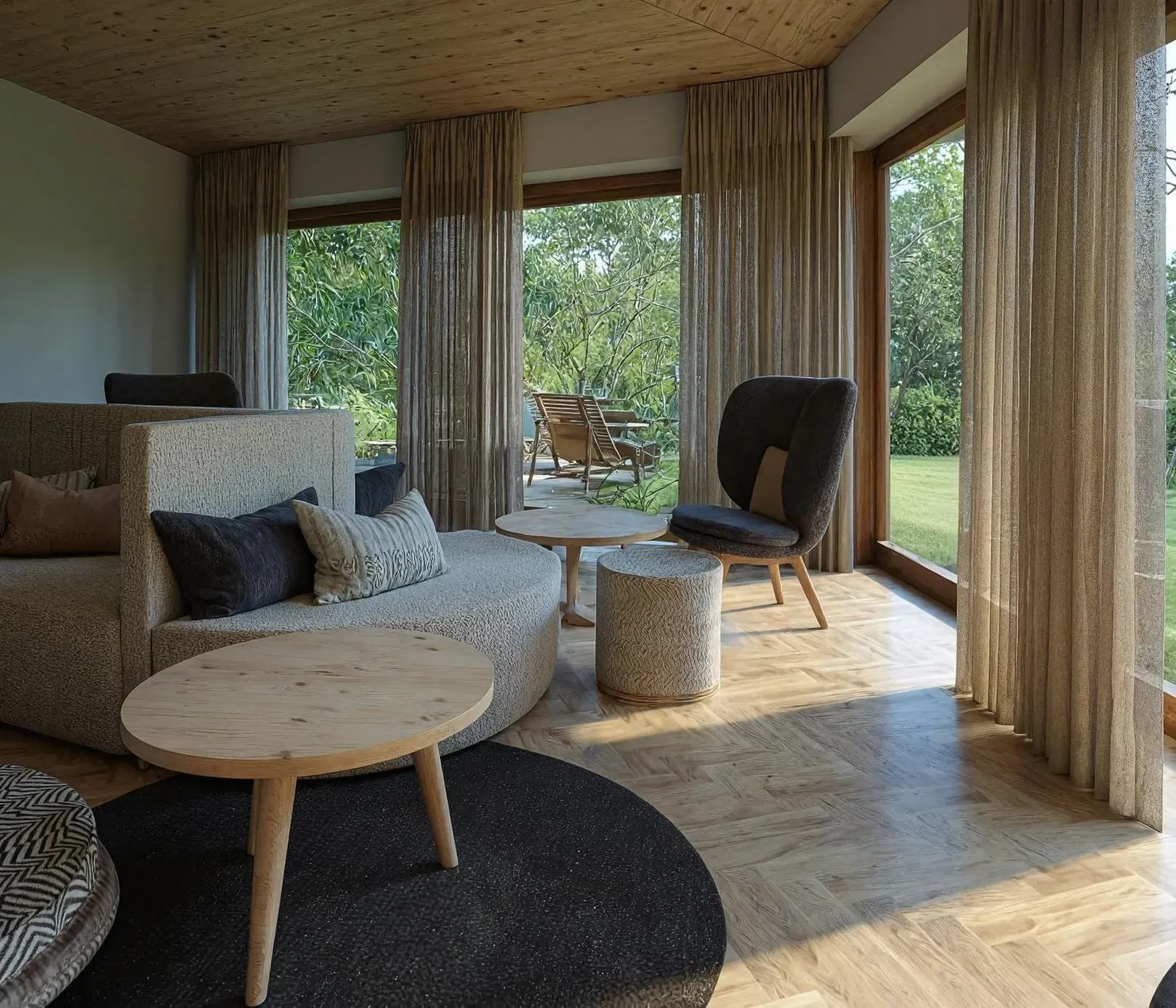 Modern living room with large windows, beige curtains, and garden view. Features cozy gray sofas, wooden tables, and a calm, inviting ambiance.